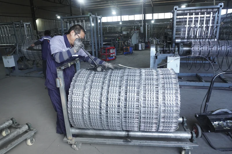 Factory operator working with a mesh roll